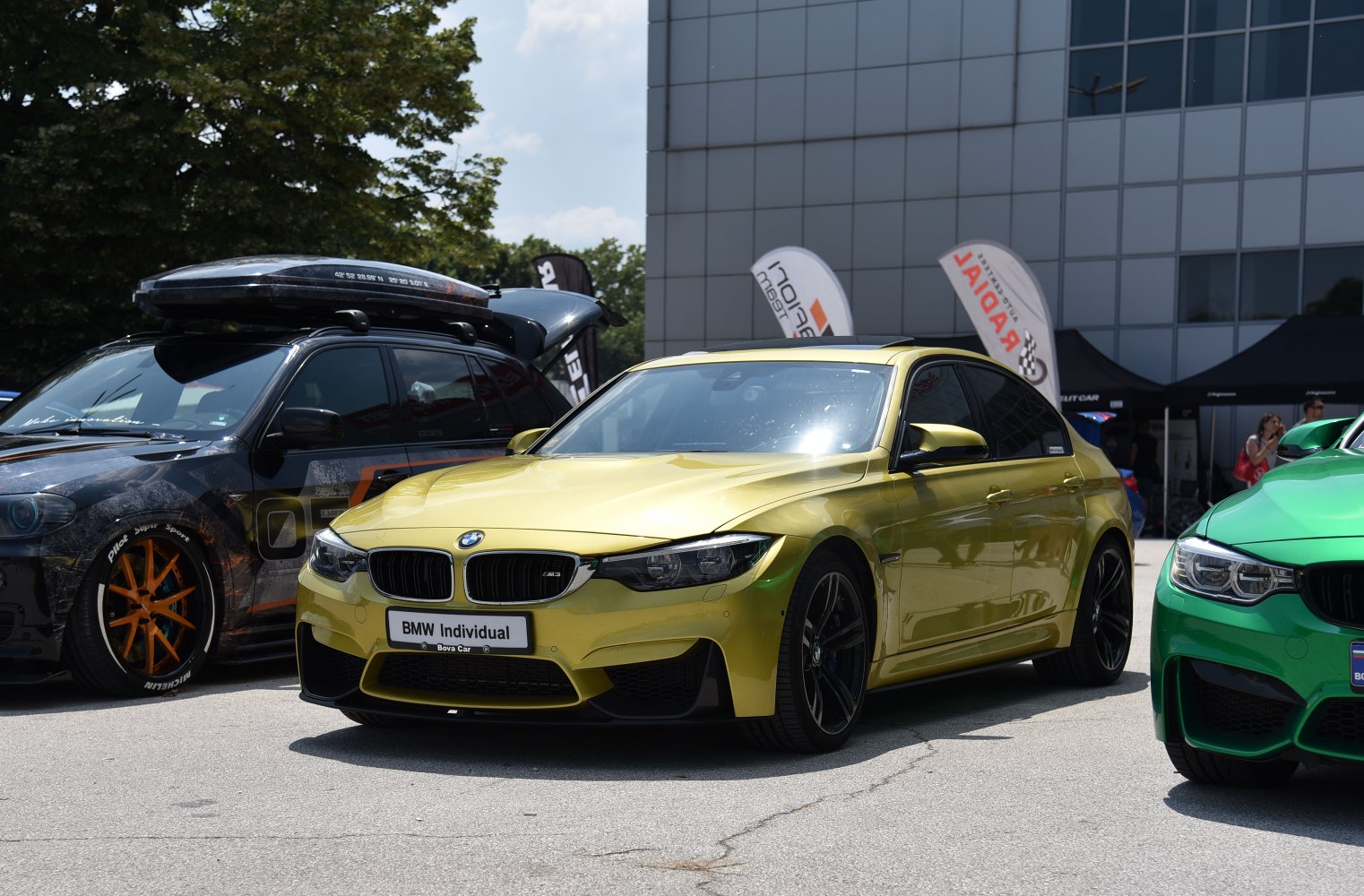 Front view of metallic yellow sporty sedan with aggressive styling