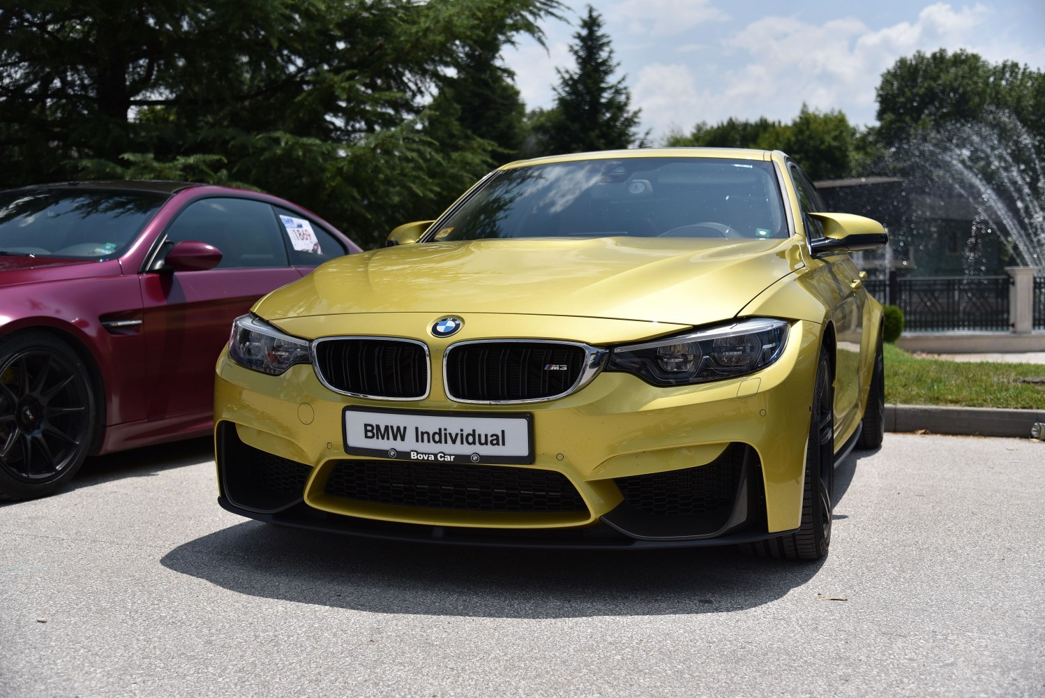 Front view of a yellow vehicle with signature kidney grille and aggressive headlights