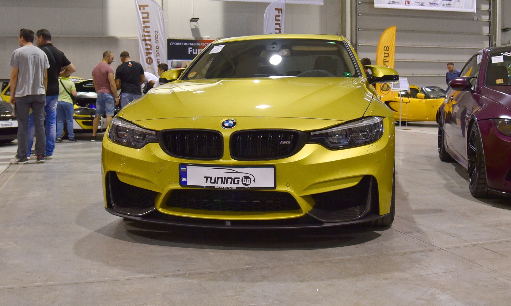 Yellow BMW M3 F80 front view with prominent grille and headlights