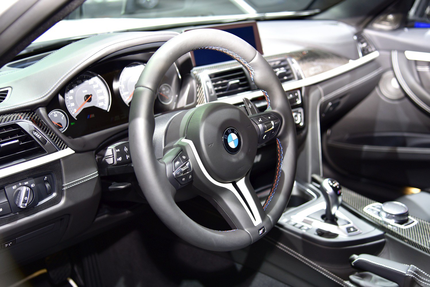 Sport steering wheel and detailed dashboard interior with carbon fiber trim