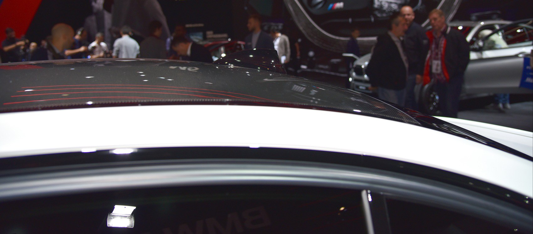 Close-up of carbon fiber roof with shark fin antenna on a sports sedan