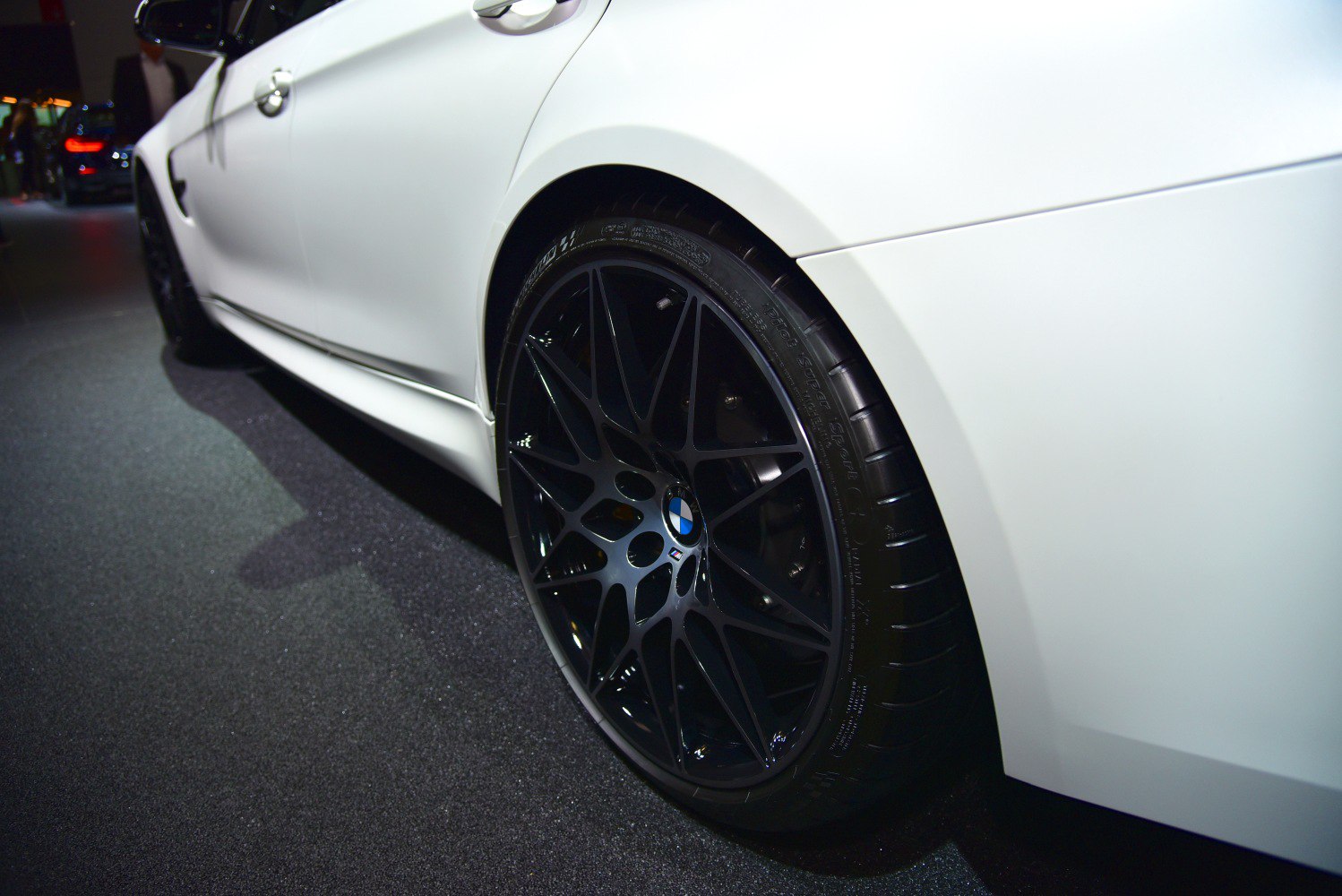 Close-up of black alloy wheel with sporty spoke design.