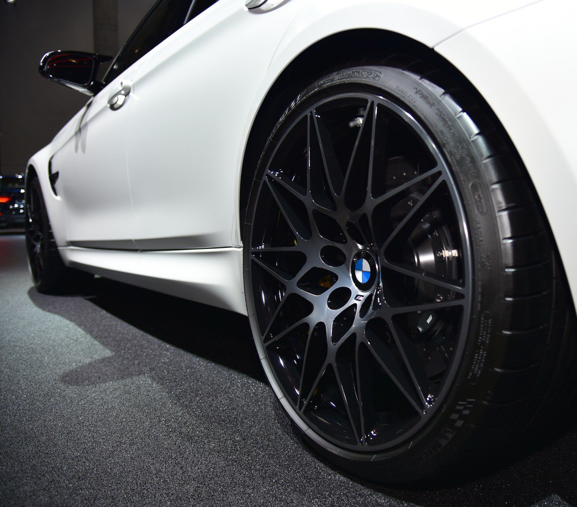 Glossy black multi-spoke alloy wheel with white side panel