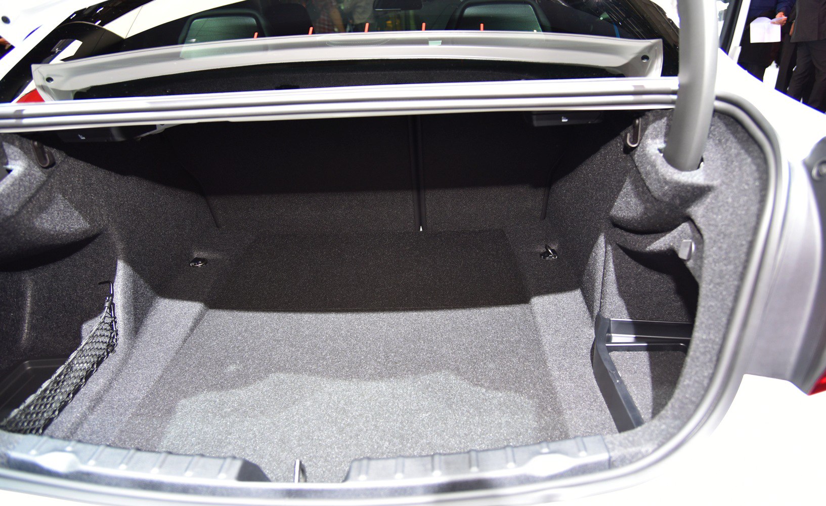 Spacious, carpeted trunk interior with storage net and support structures