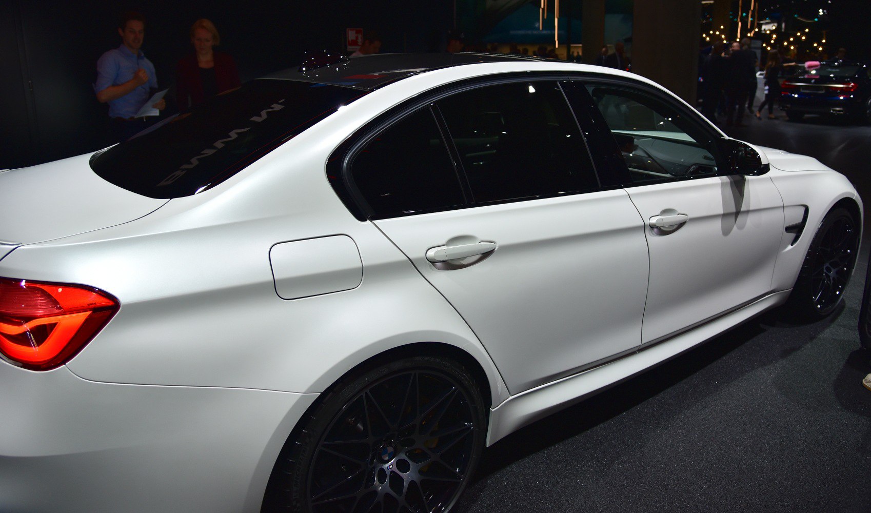 Side and rear view showing black wheels and tinted windows