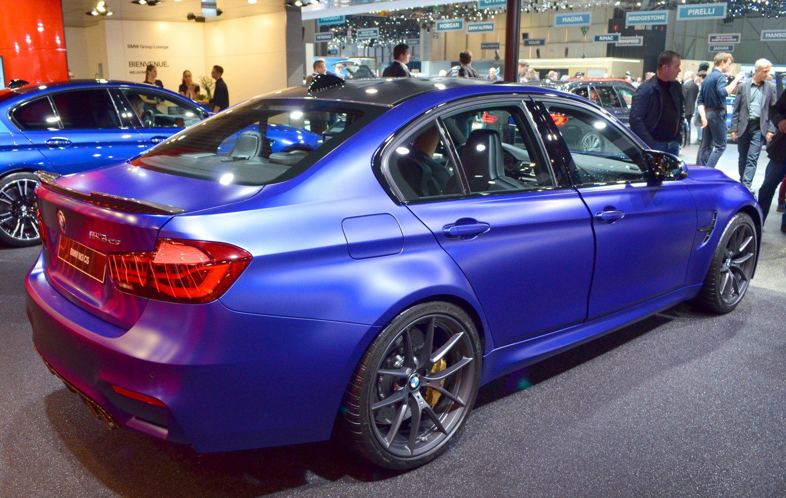 Rear and side view of a sporty sedan with black alloy wheels and sleek aerodynamic design.