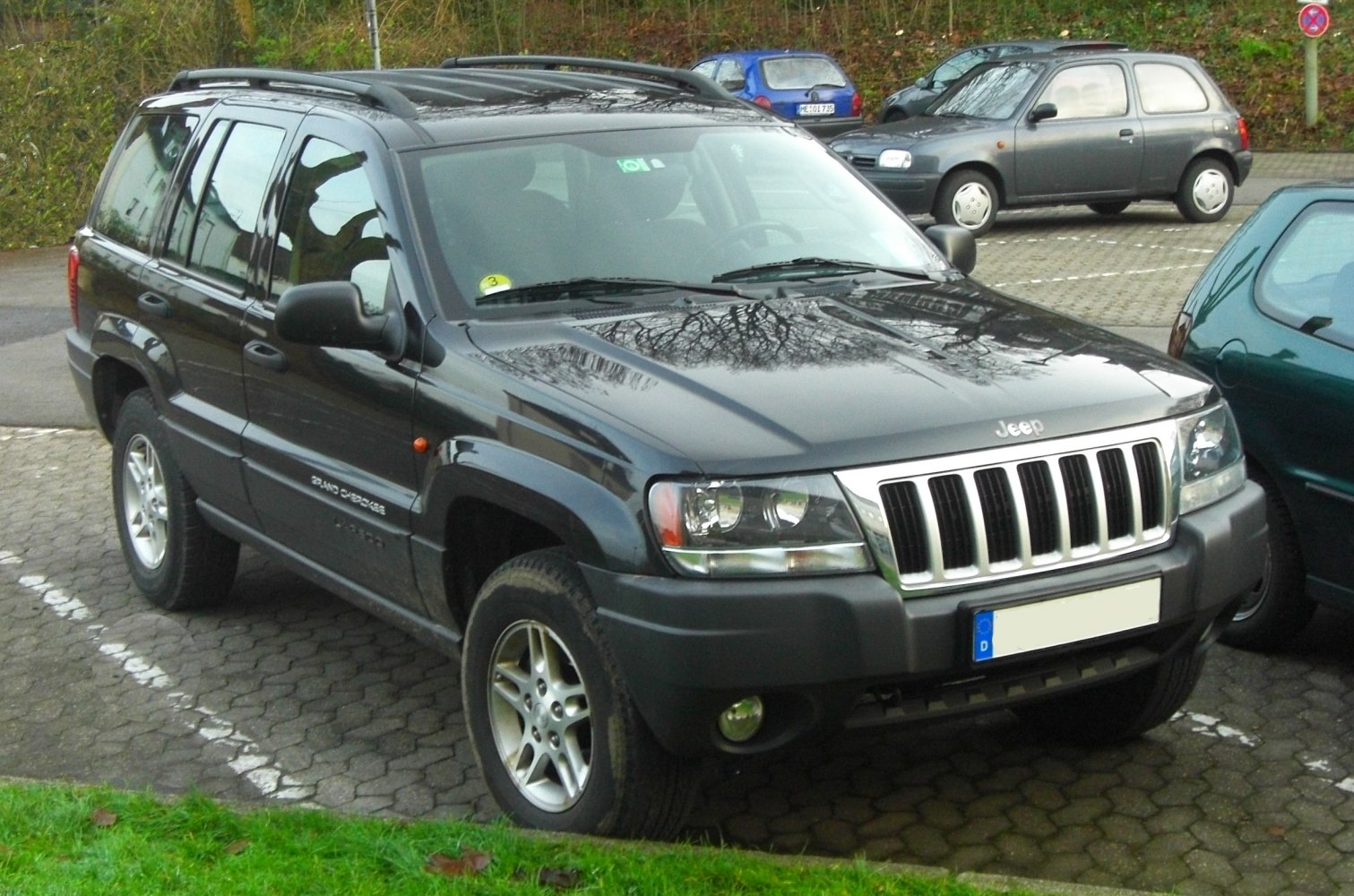 Front angled view of SUV with iconic Jeep grille and rugged design