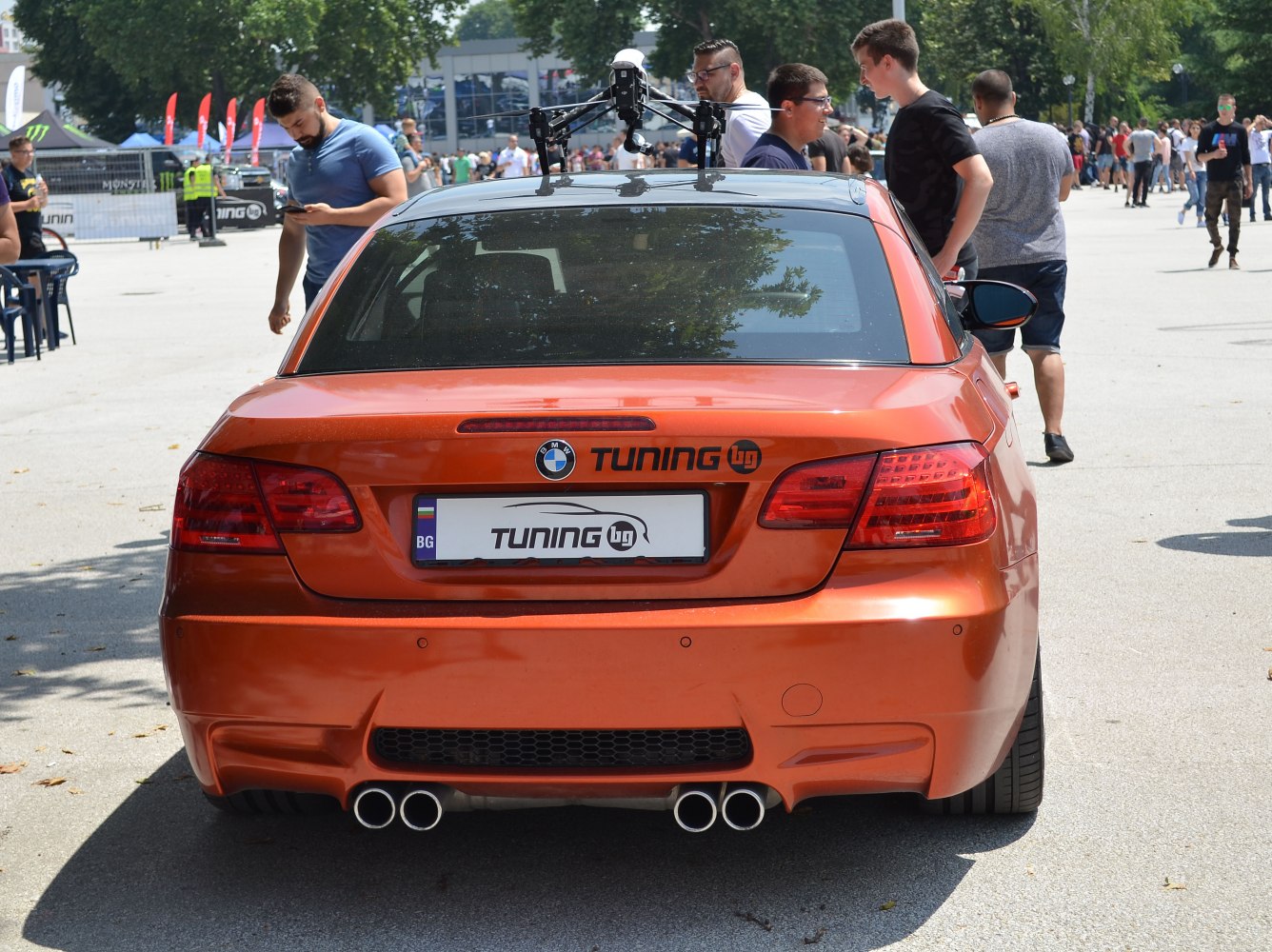 Rear view of orange BMW M3 Convertible with quad exhaust and tuning logo