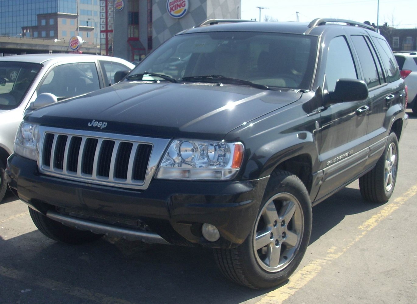 Seven-slot grille and alloy wheels on 2004 SUV parked outdoors