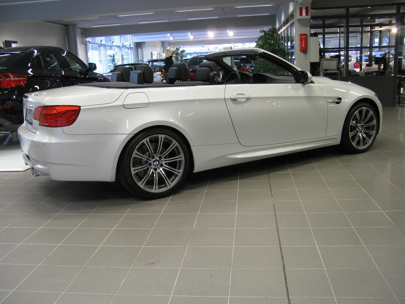 Side view of a convertible with open roof and alloy wheels
