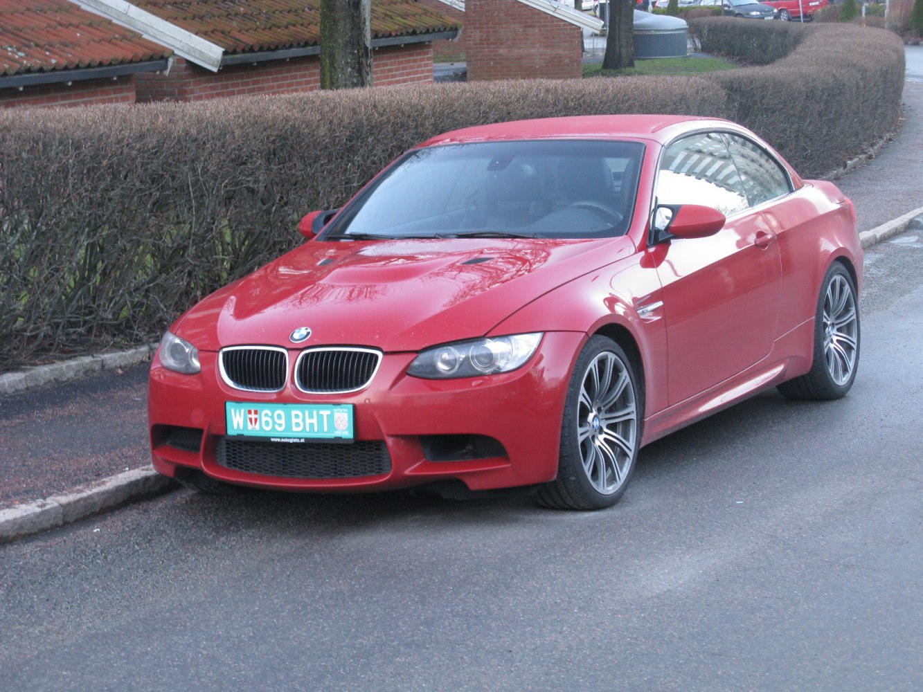 Front and side view of sporty red convertible with alloy wheels