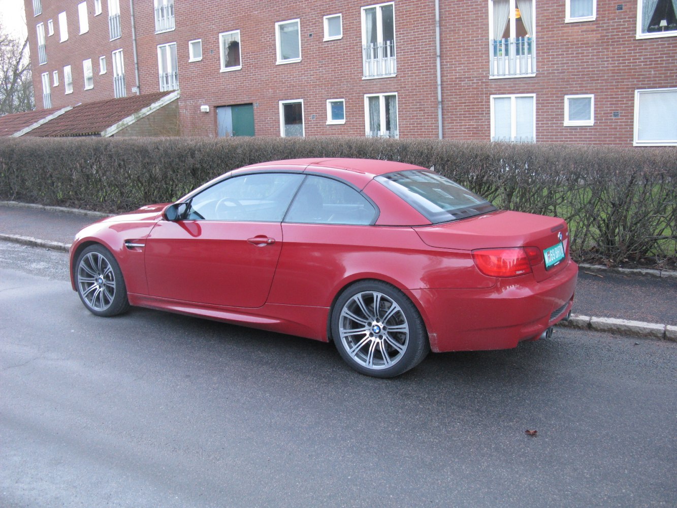 Red convertible coupe with hardtop roof and multi-spoke alloy wheels