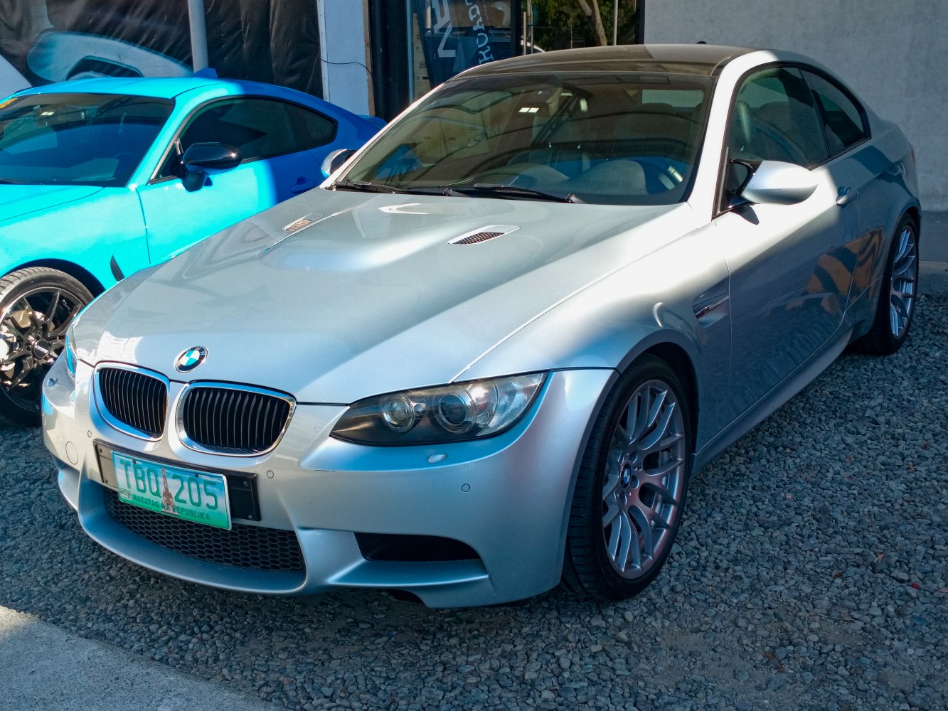 Silver coupe with hood vents and sporty front design