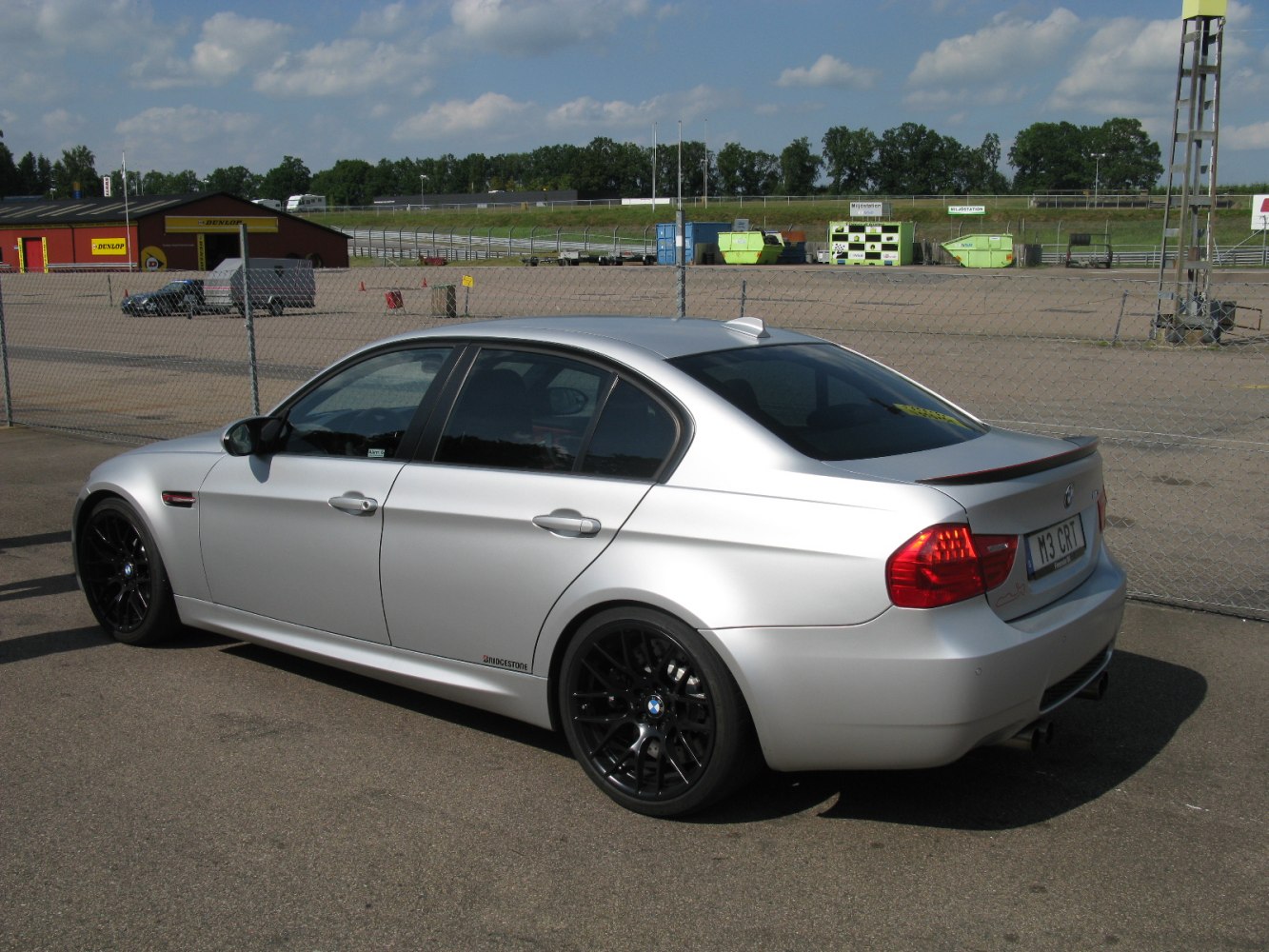 Silver sedan with black rims side and rear view