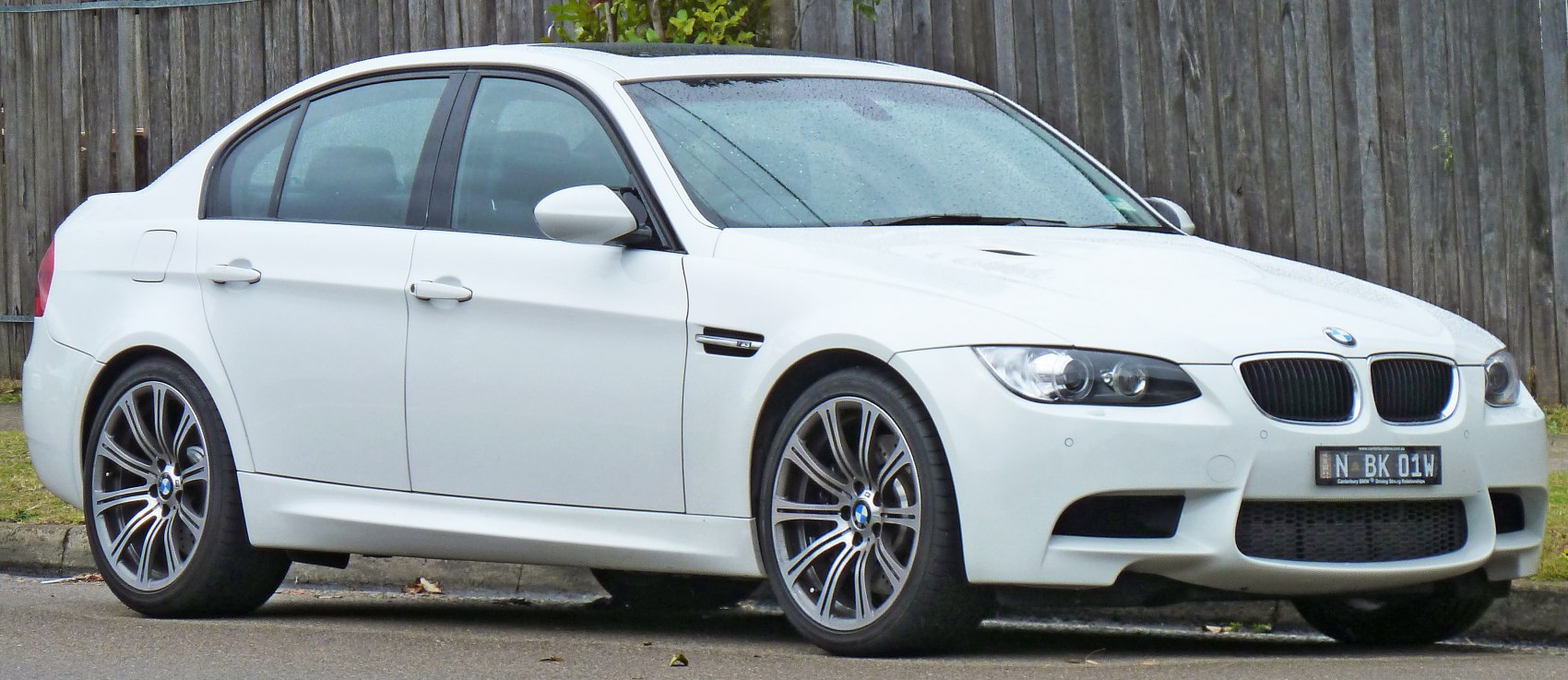 White four-door sedan with alloy wheels and aggressive front design