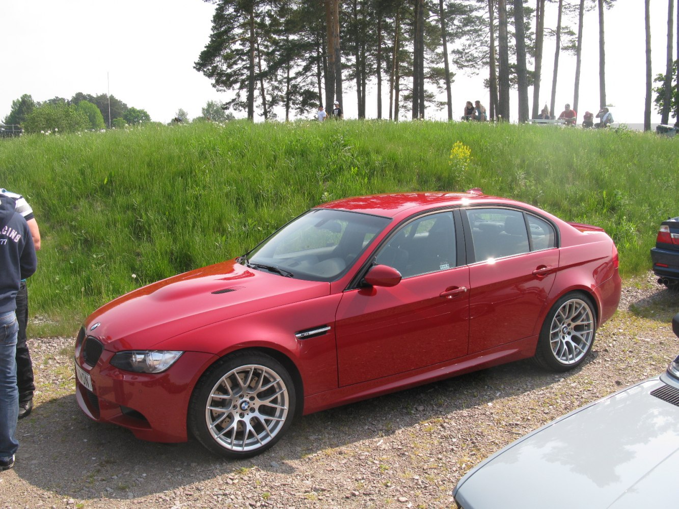 Side view of red sporty sedan with alloy wheels