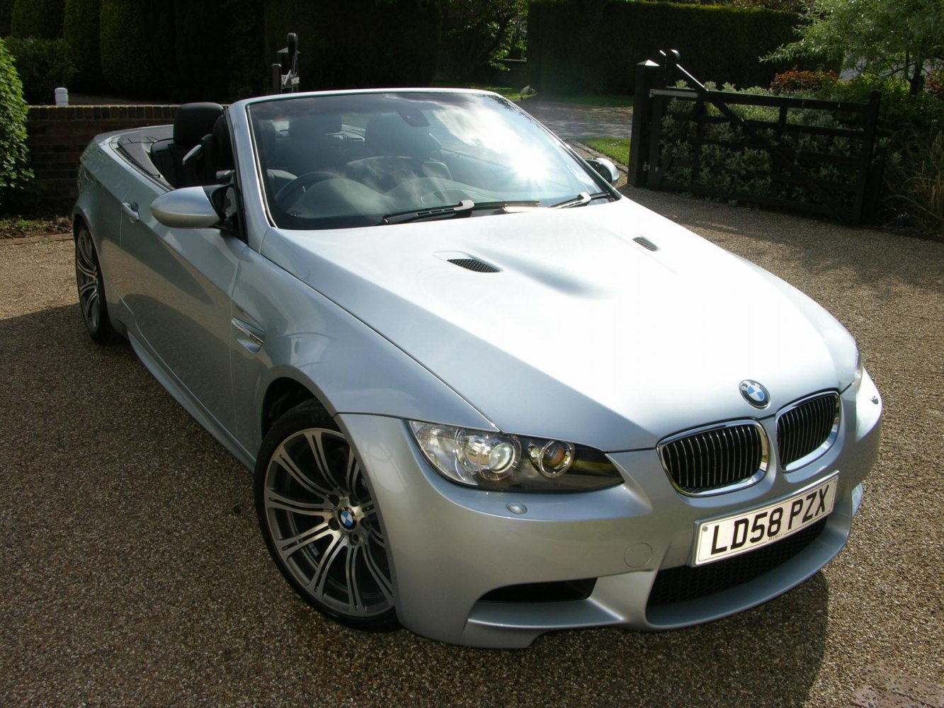 Silver convertible with open roof and sporty front design