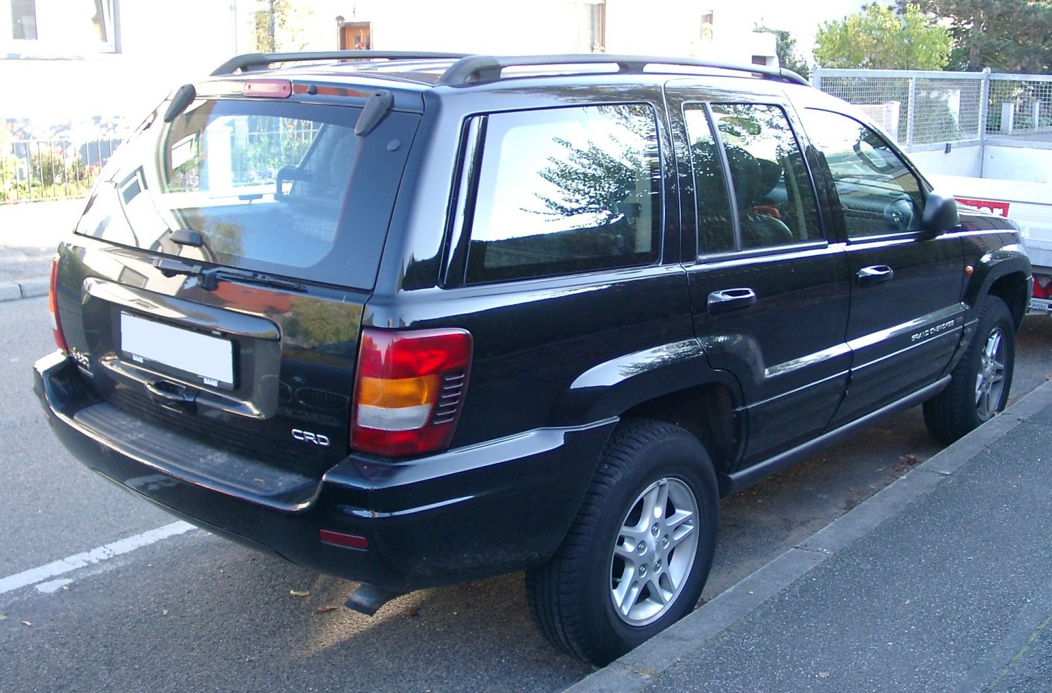 Rear side view of SUV with roof rails and alloy wheels