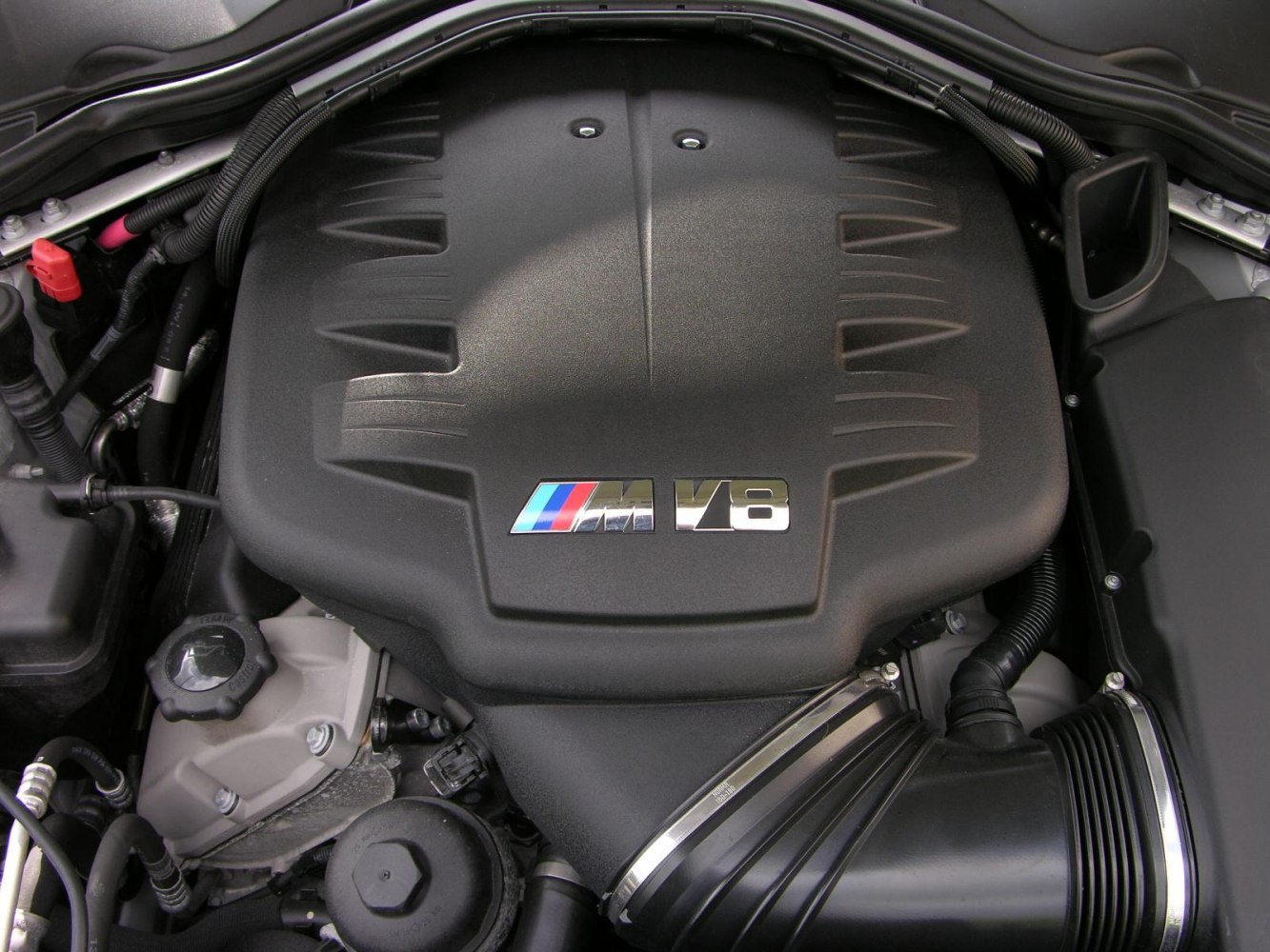 Close-up of a BMW M series V8 engine cover with distinctive design