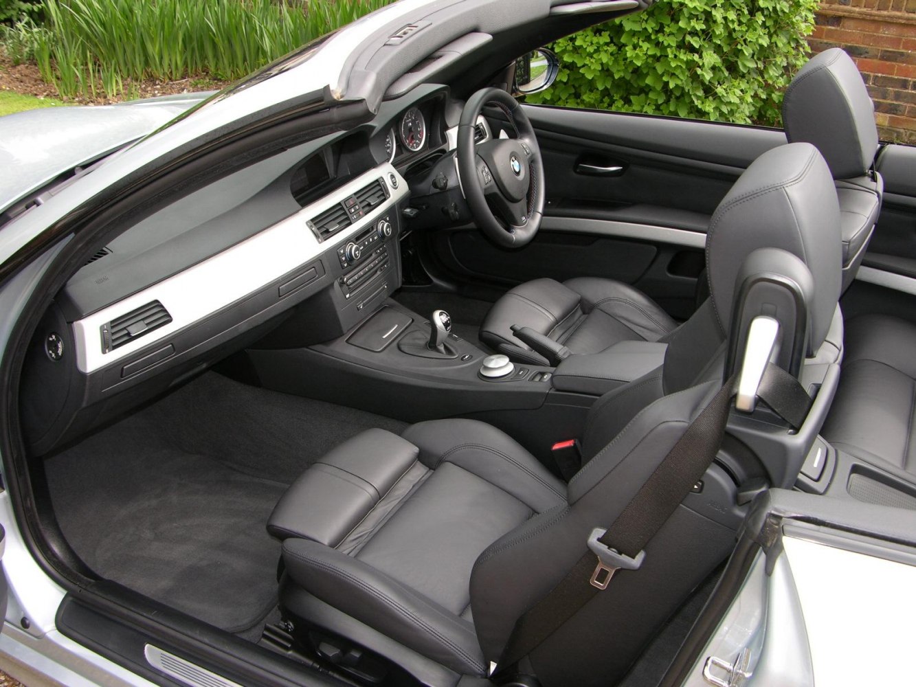 Black leather sporty seats and modern dashboard design in convertible interior