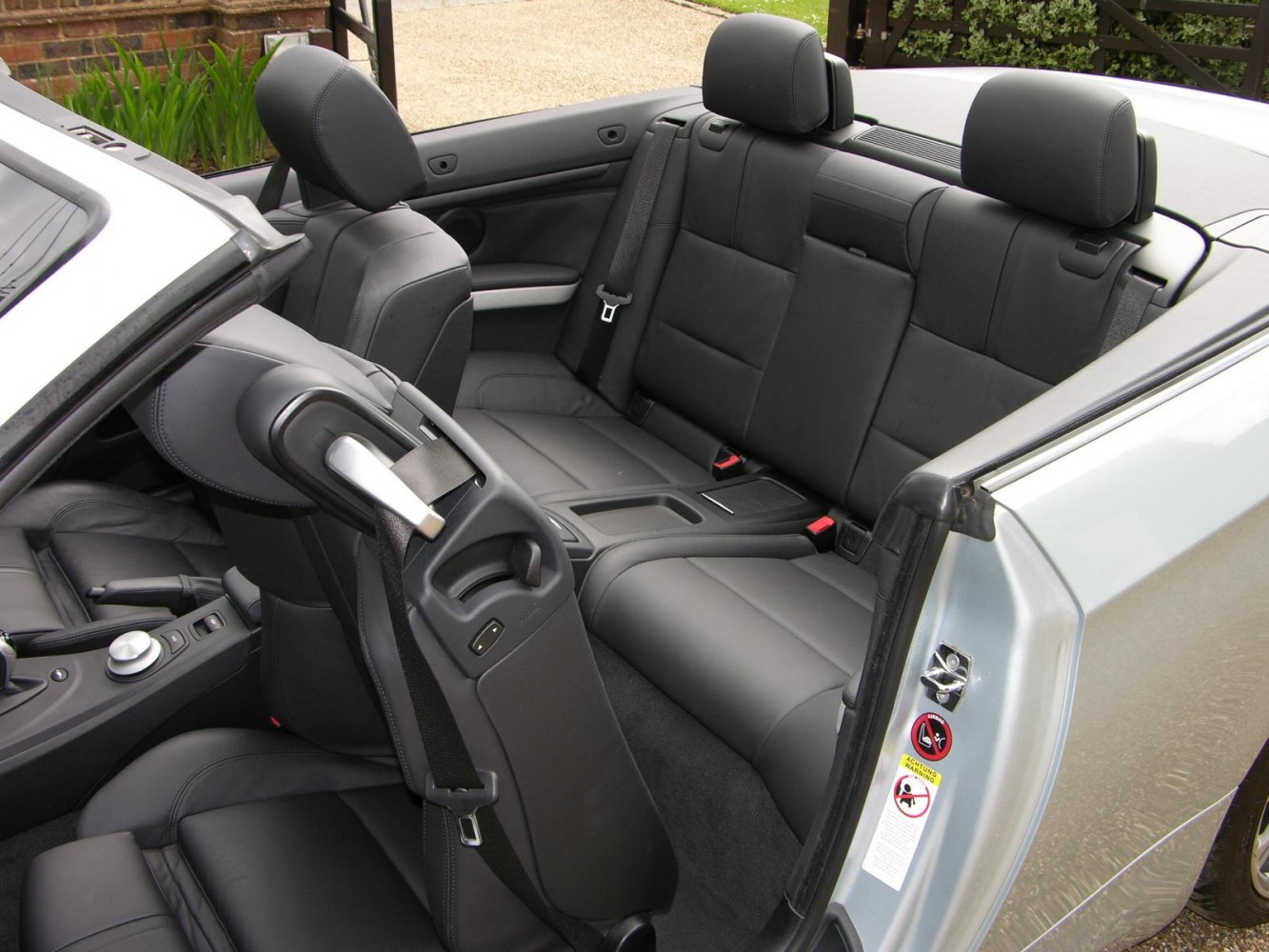 Black leather rear seats with seat belts and interior door detail