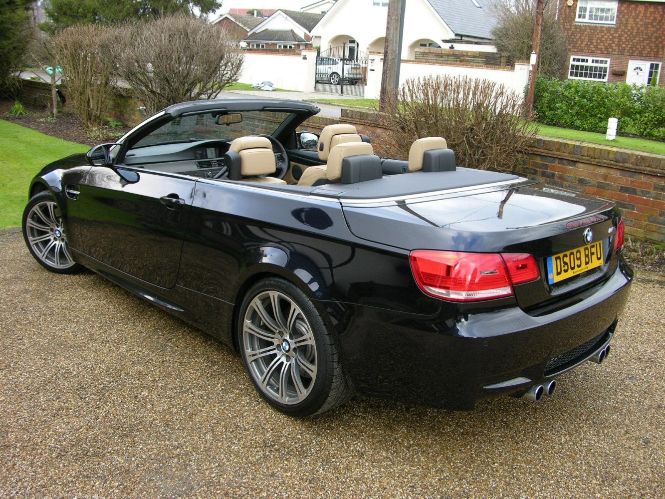 Rear view of convertible with quad exhausts and beige seats