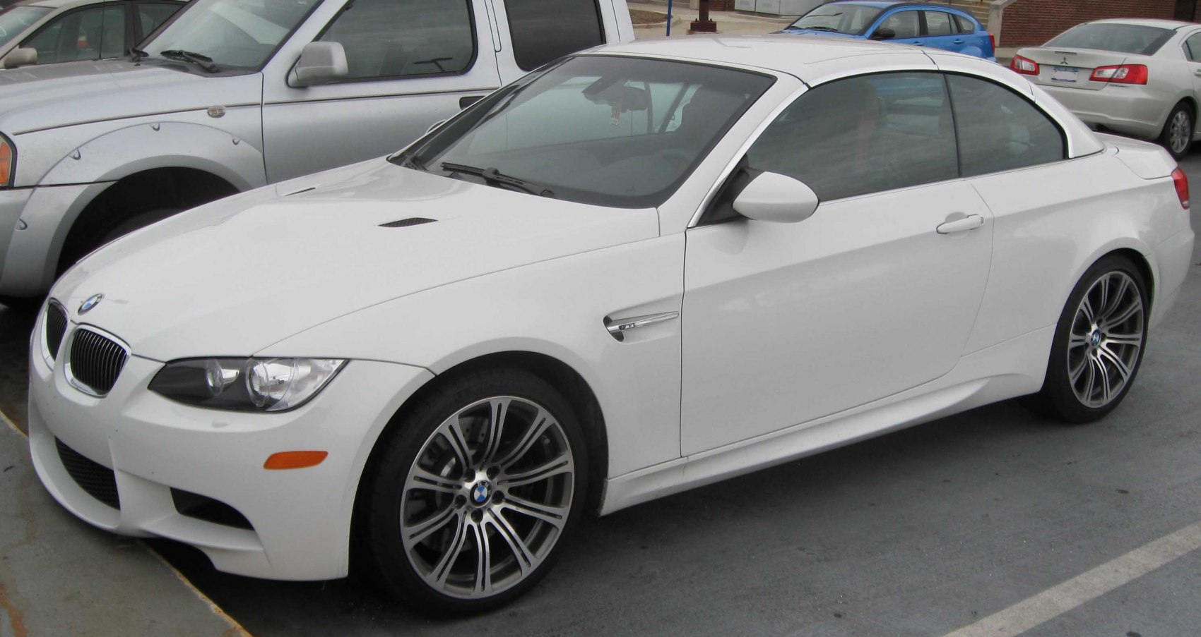 White sporty convertible front side profile with alloy wheels