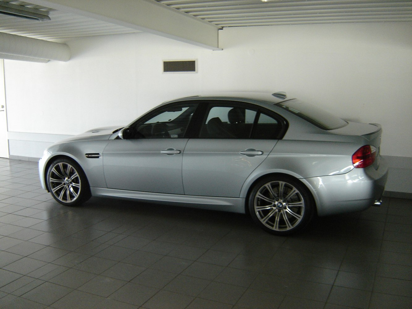 Silver sedan with multi-spoke wheels and side air vents