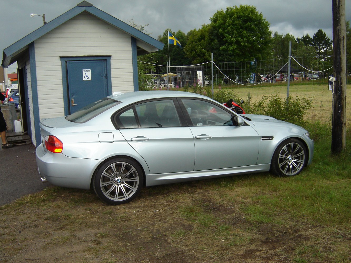 Silver sedan with alloy wheels side profile and sporty design.