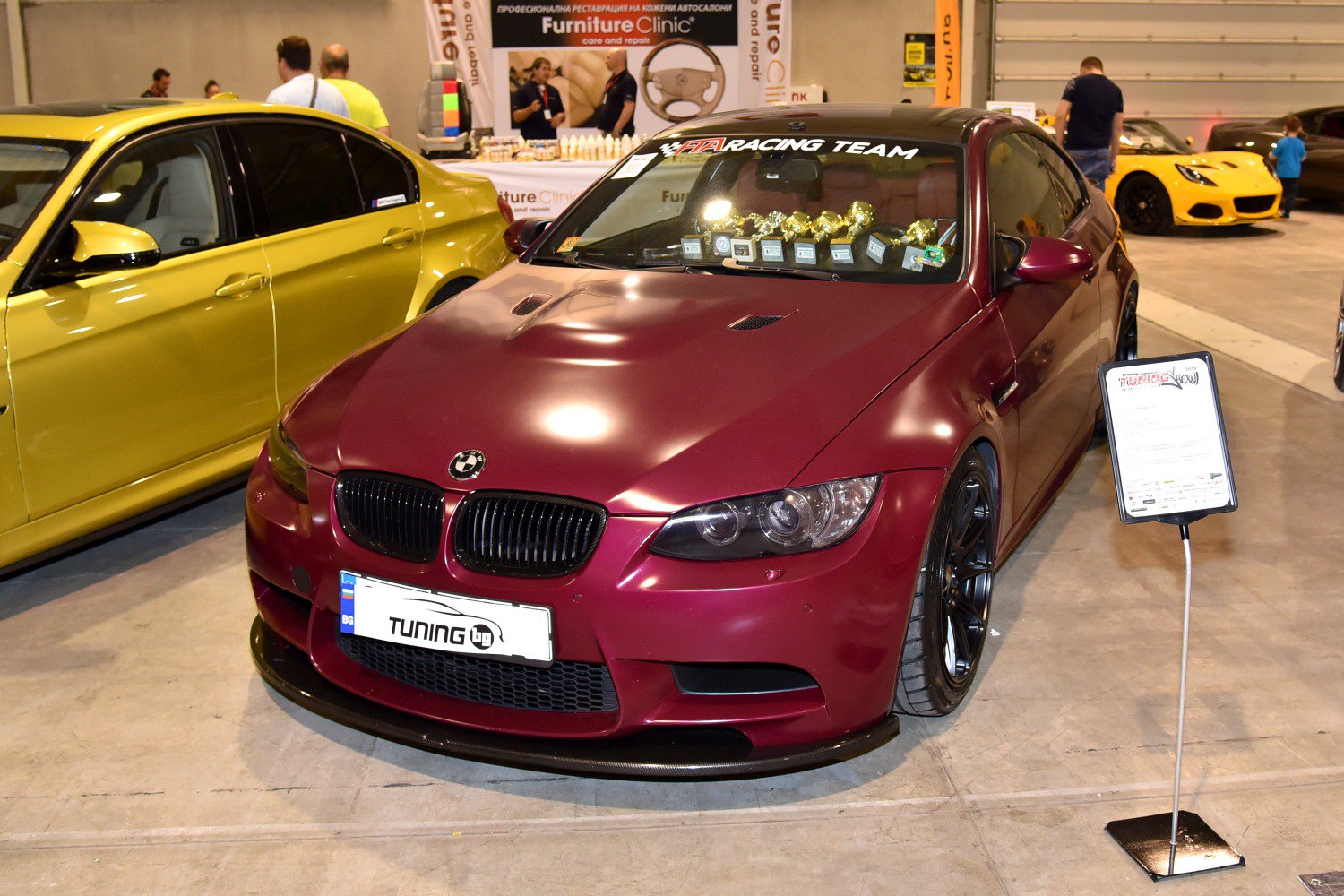 Matte red coupe with black wheels and front splitter.