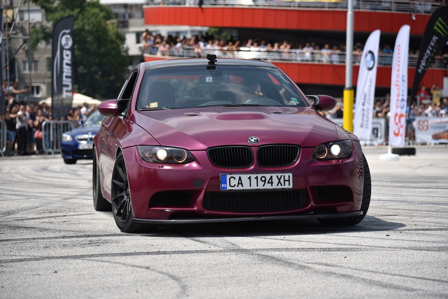 Front view of a car with unique hood scoop and black wheels