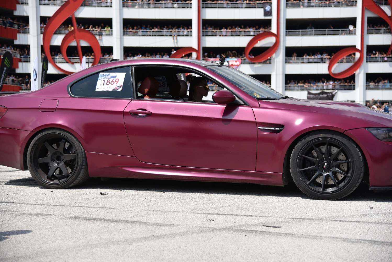 Side profile of matte purple coupe with black multi-spoke wheels