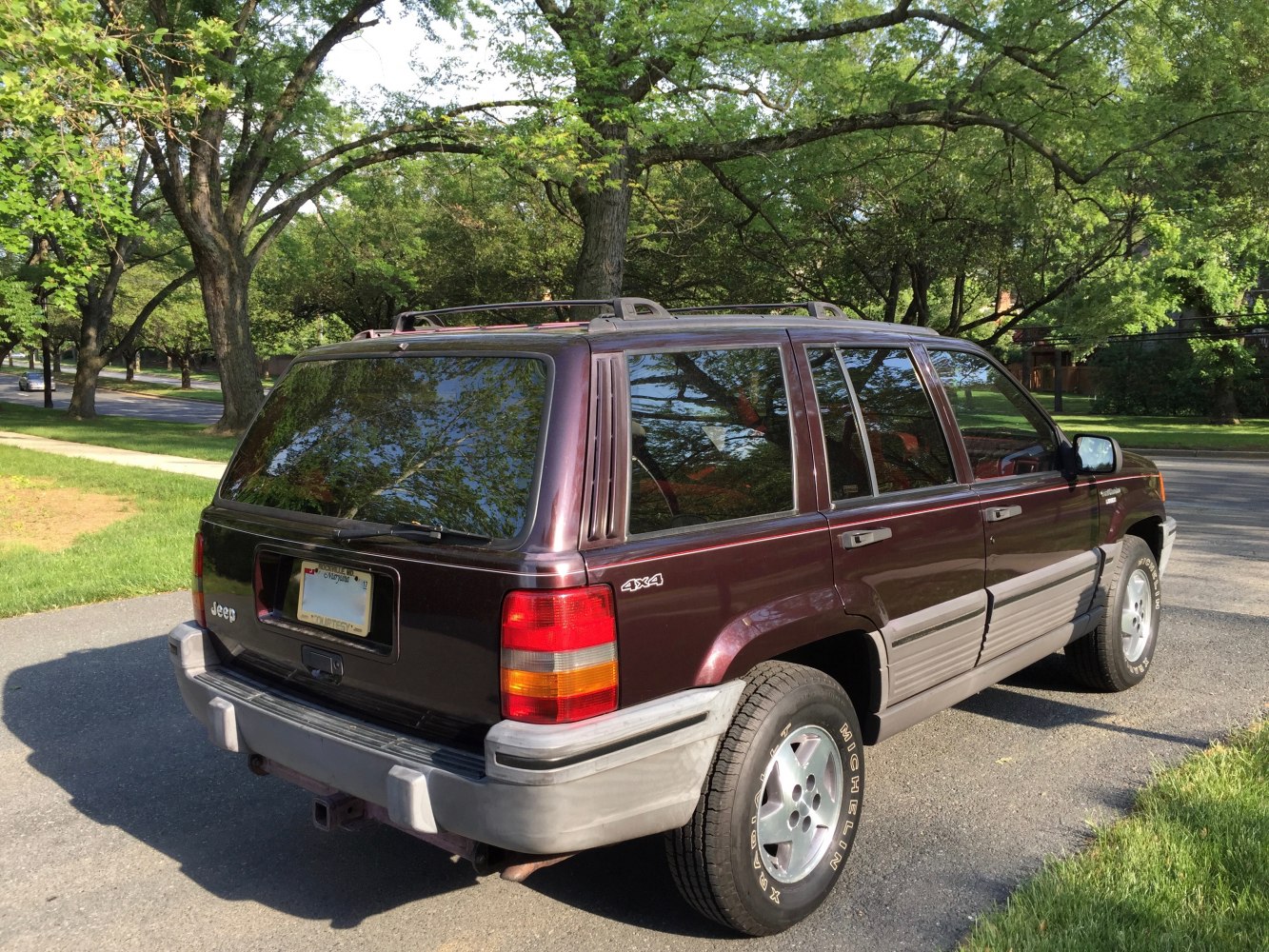 Rear side view of classic 4x4 SUV with tinted windows and roof rack
