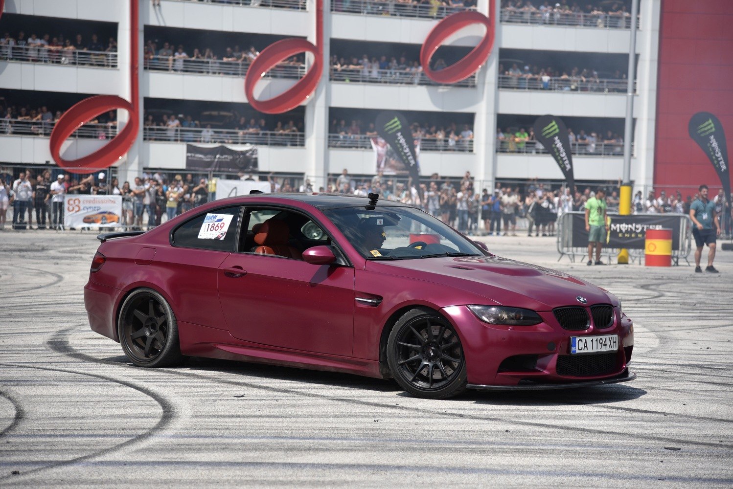 Matte burgundy coupe with black alloy wheels and sporty stance
