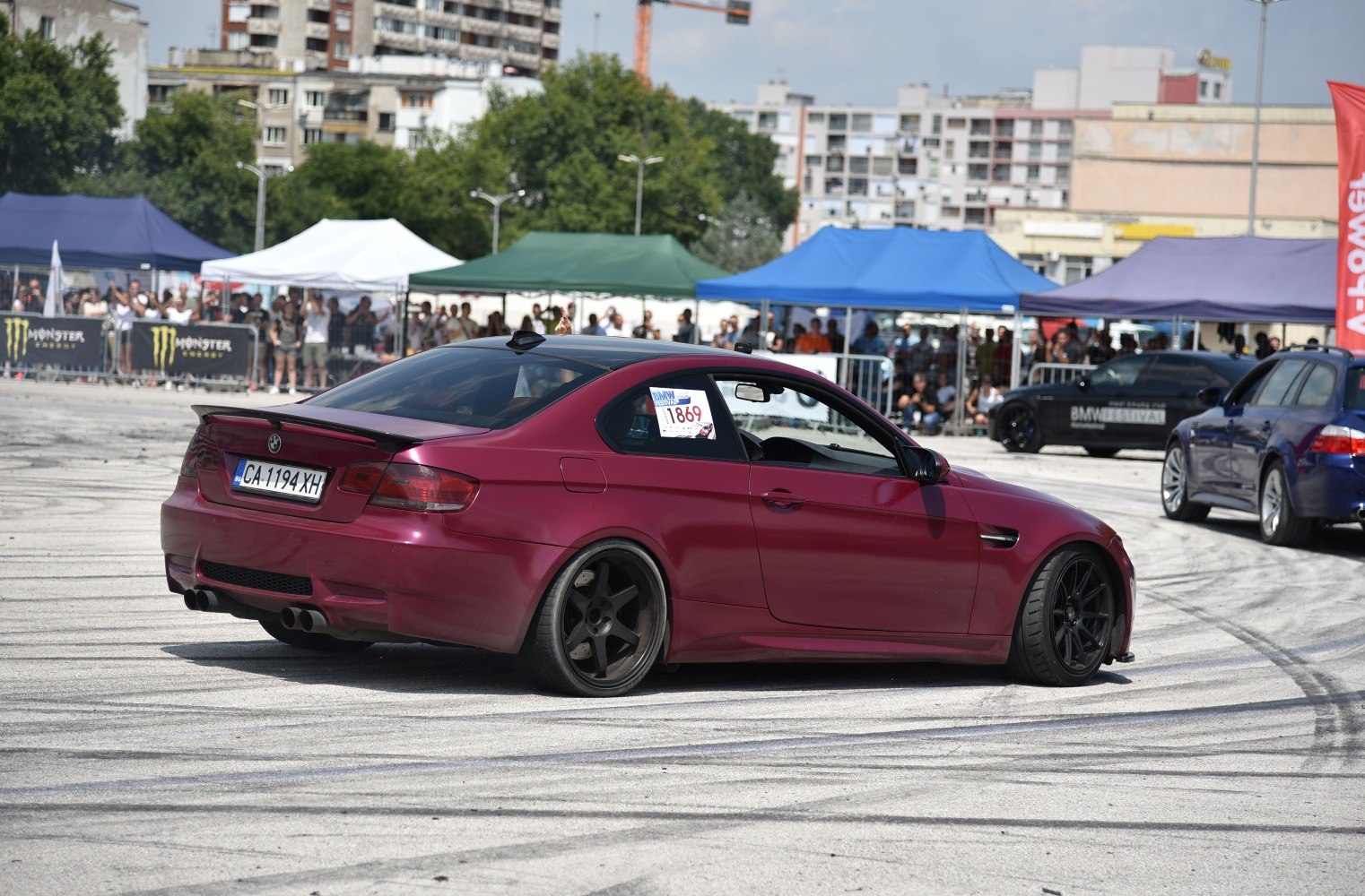 Matte red coupe drifting with black 5-spoke rims