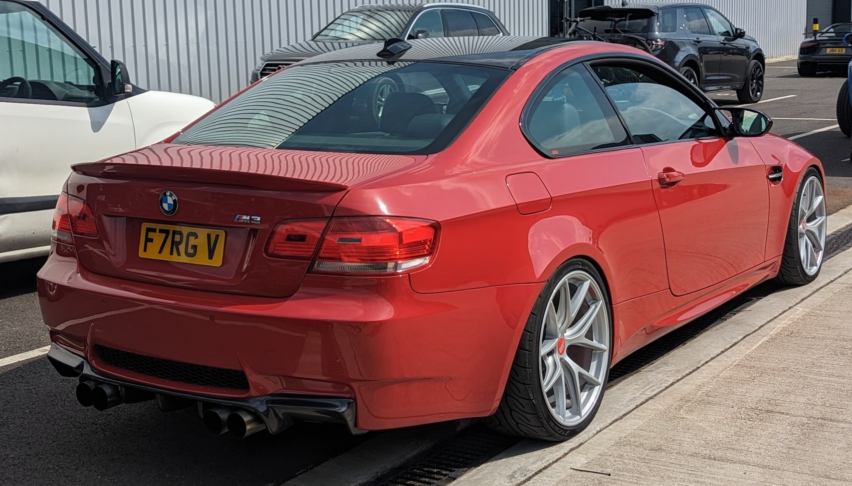 Rear view of red coupe with quad exhaust and silver alloy wheels