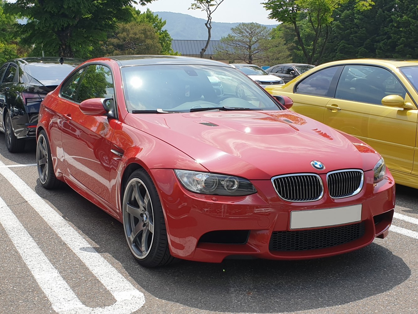 Red sports coupe with aggressive headlights and kidney grille