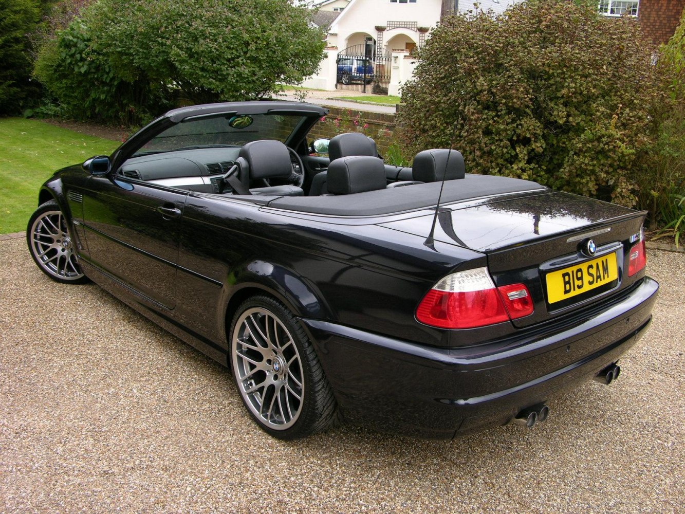Rear and side view of convertible with open top and alloy wheels