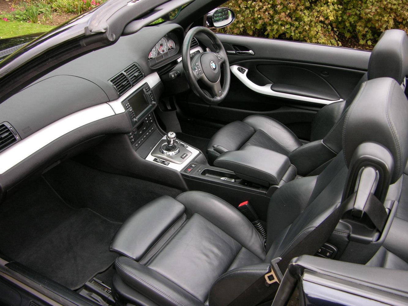 Black leather sport seats and manual gearbox in convertible interior