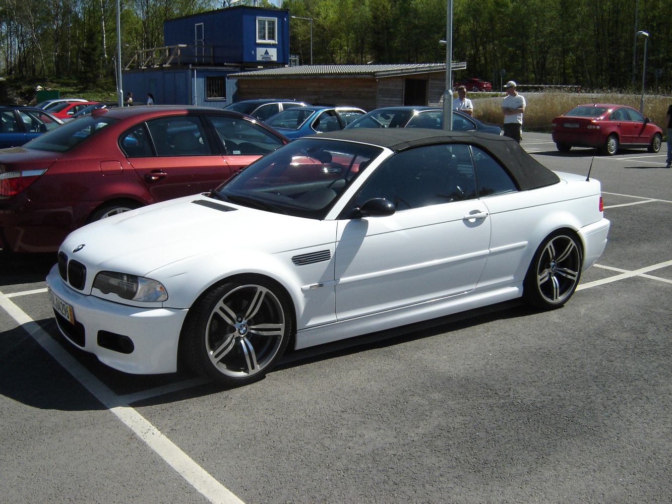 White convertible with black soft top and sporty alloy wheels
