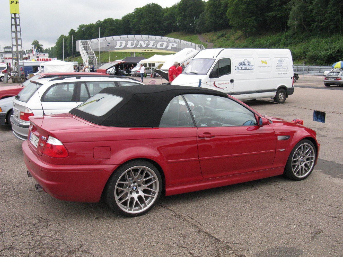 Red convertible with black soft top and alloy wheels