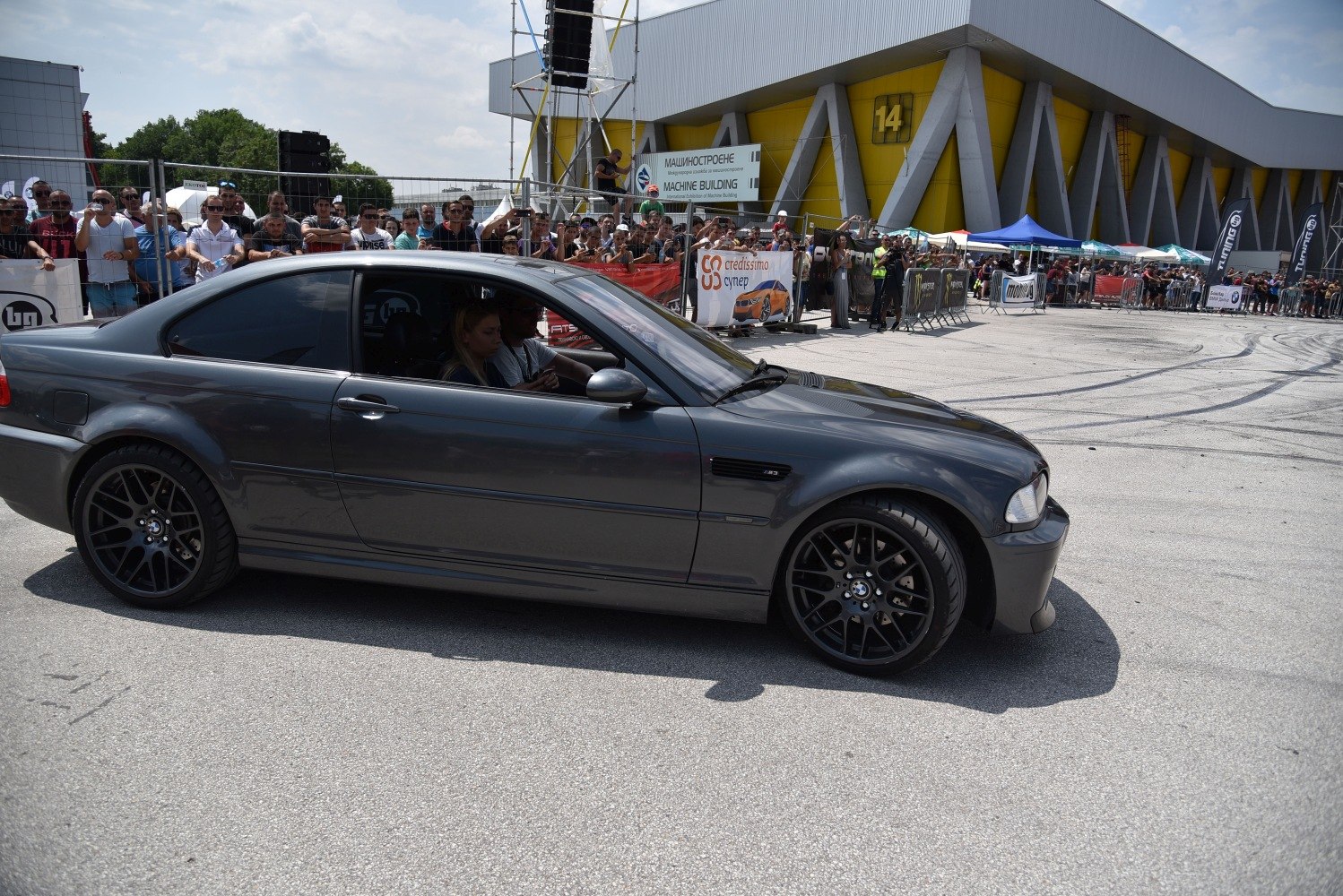 Side profile of a grey coupe with black alloy wheels