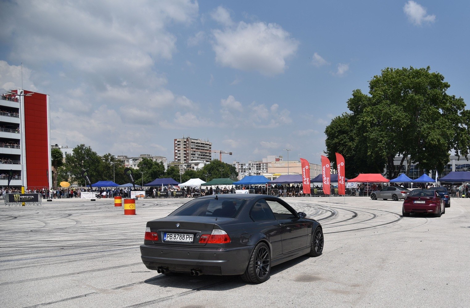 Black BMW M3 E46 coupe rear view on tire-marked pavement