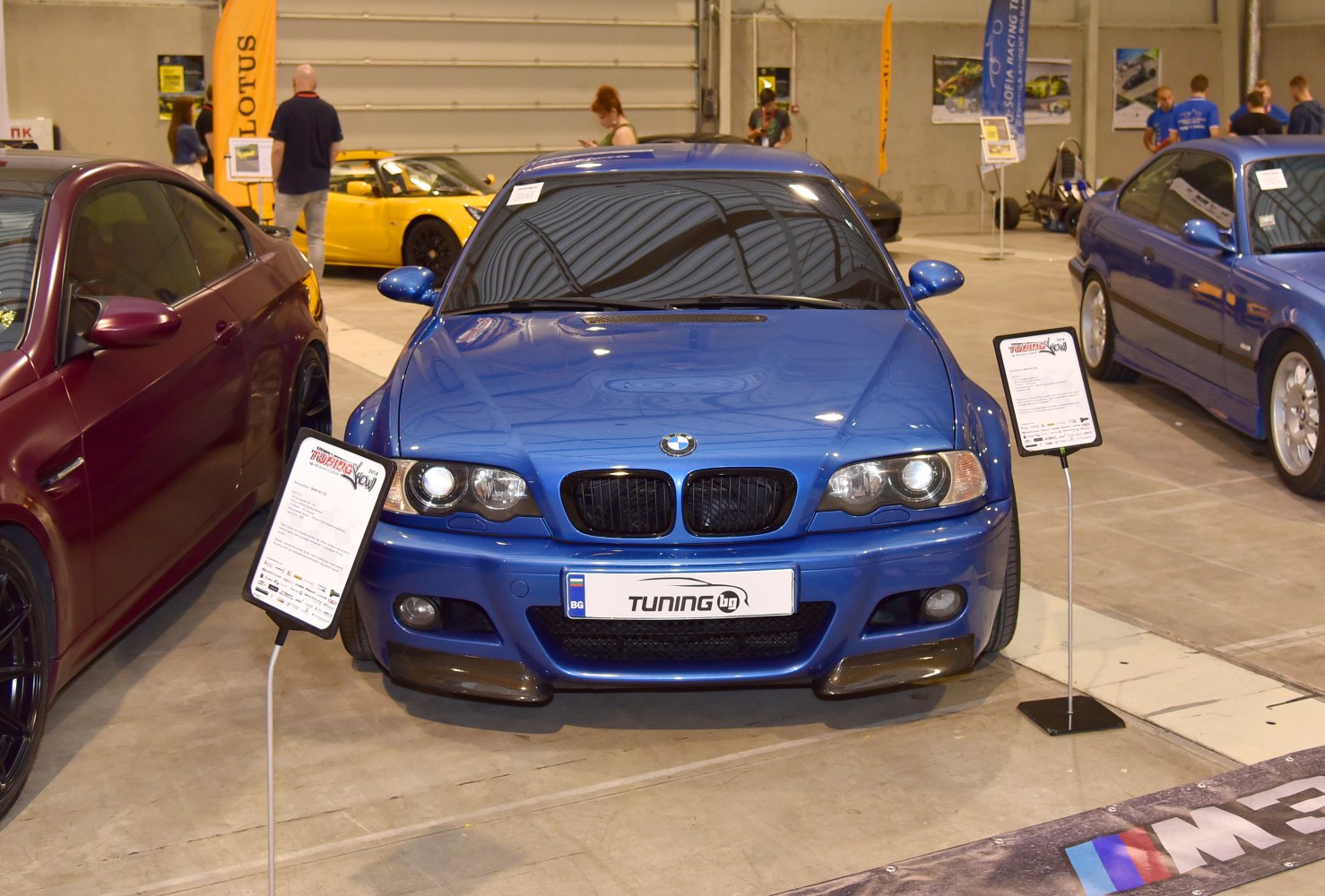 Blue BMW E46 M3 Coupe front view with headlights and hood vent