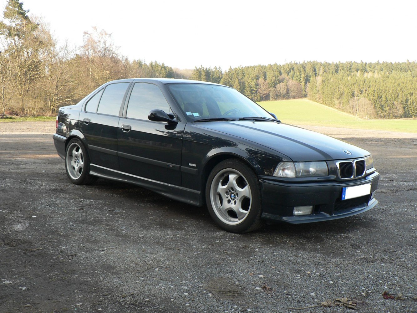 Black sedan with alloy wheels and front three-quarter view