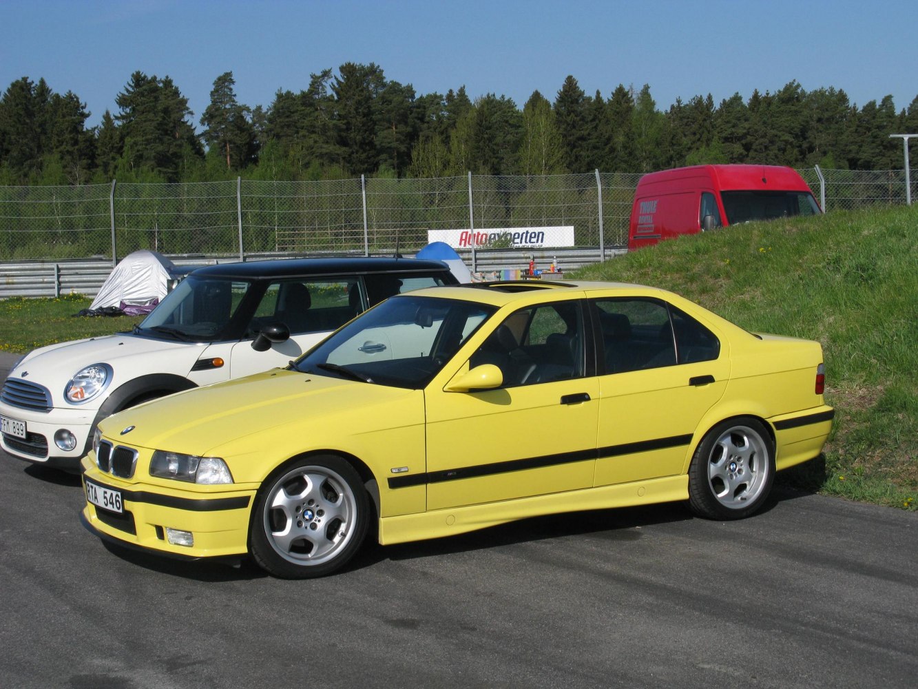 Yellow sedan with sporty alloy wheels and black trim