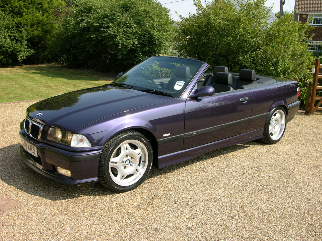 Convertible sports car with alloy wheels and dual headlights