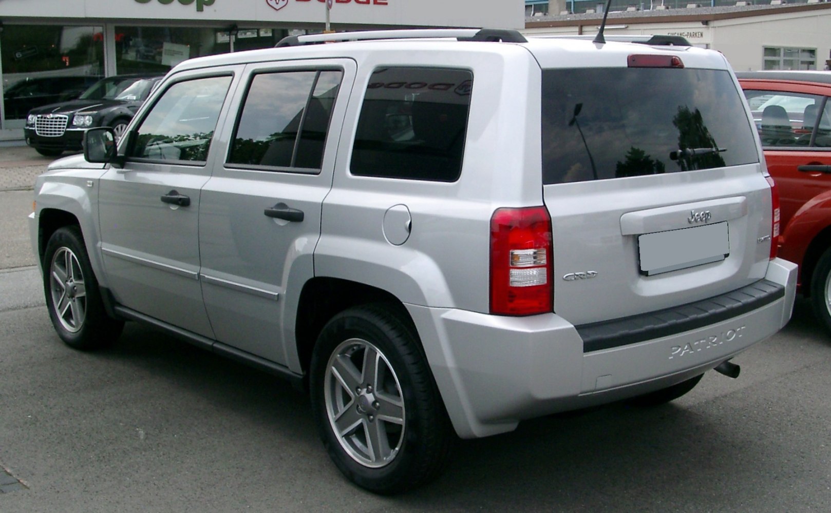 Silver SUV rear side view with boxy design and alloy wheels