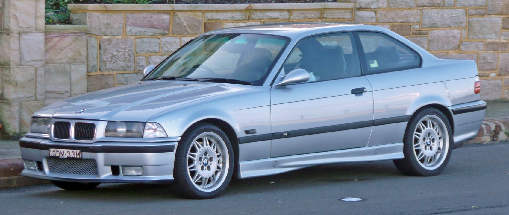 Silver coupe with sporty front side profile and alloy wheels