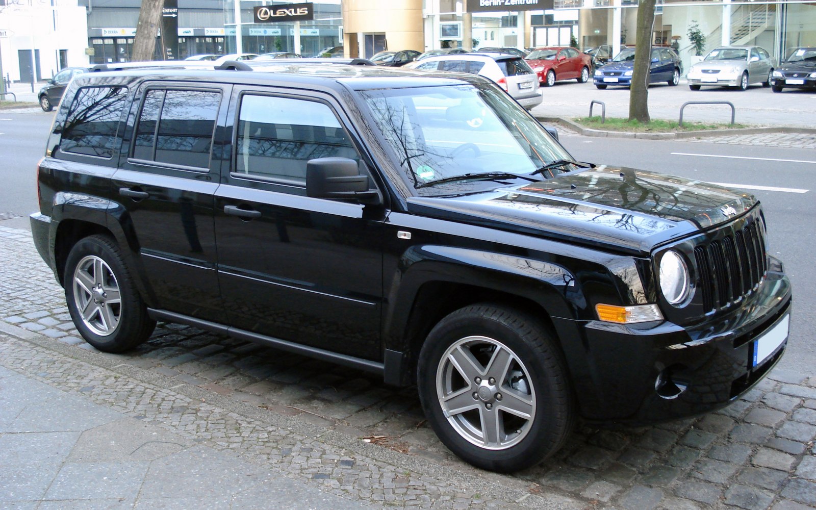 Black SUV with rounded headlights and vertical-slat grille
